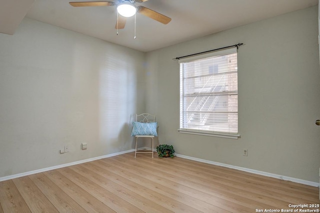 unfurnished room featuring wood finished floors, baseboards, and ceiling fan