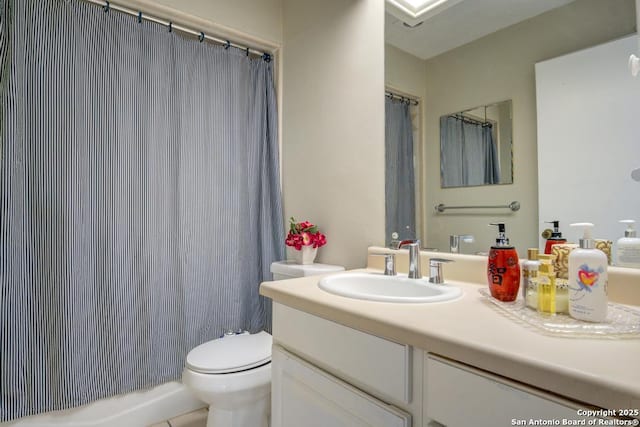 bathroom featuring toilet, vanity, and a shower with curtain