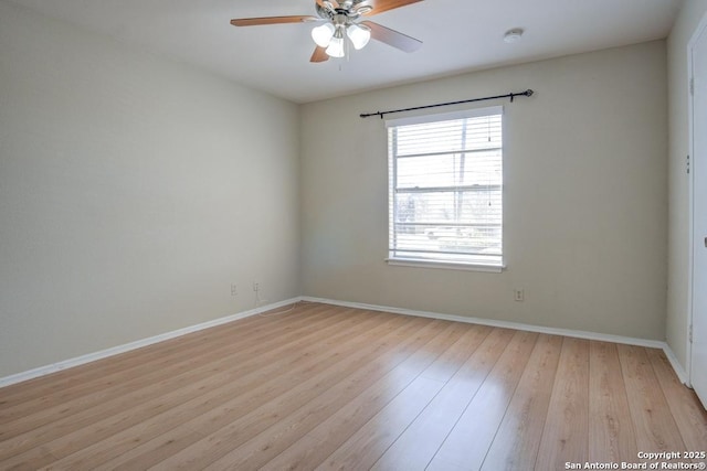 spare room featuring light wood-style flooring, baseboards, and ceiling fan