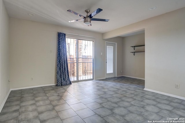 unfurnished room featuring a ceiling fan and baseboards