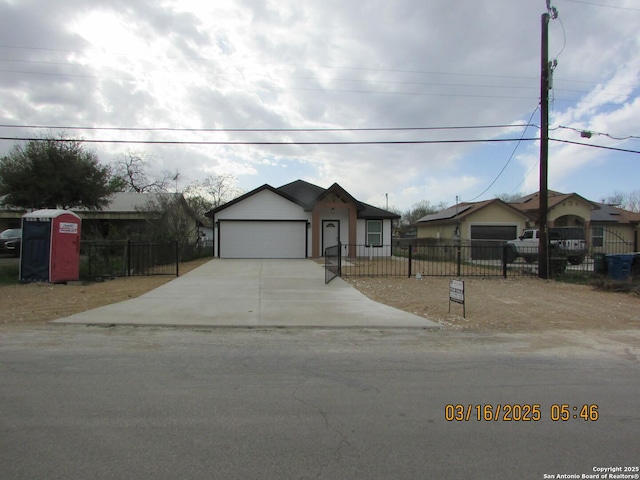 view of front of property with a fenced front yard and concrete driveway