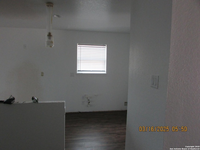 unfurnished room with wood finished floors