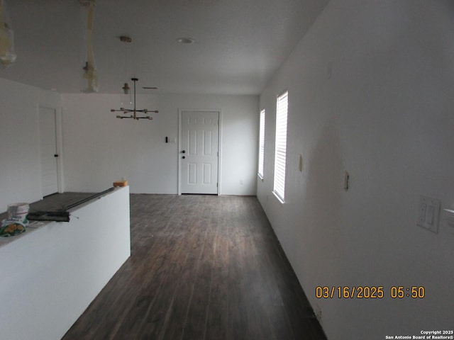 corridor featuring dark wood-style flooring