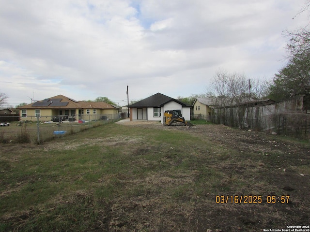 view of yard featuring a garage and fence