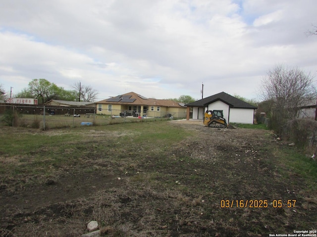 exterior space with an outdoor structure, a front lawn, and fence