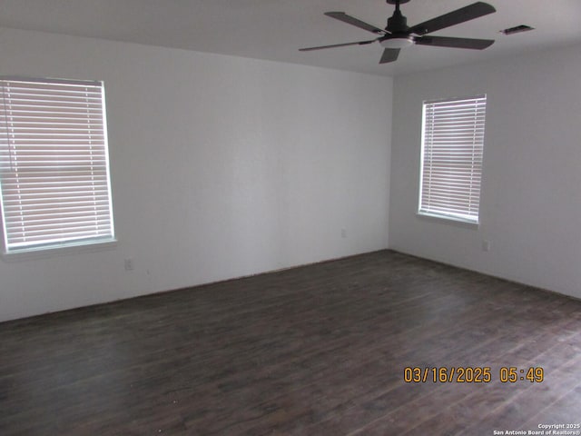 spare room with visible vents, ceiling fan, and wood finished floors