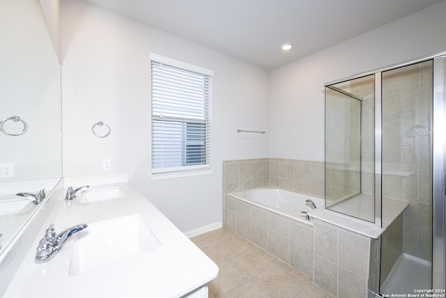 bathroom featuring tile patterned floors, a garden tub, a sink, double vanity, and tiled shower