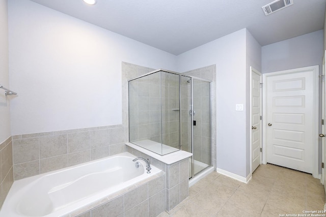 bathroom with tile patterned floors, visible vents, a stall shower, and a bath