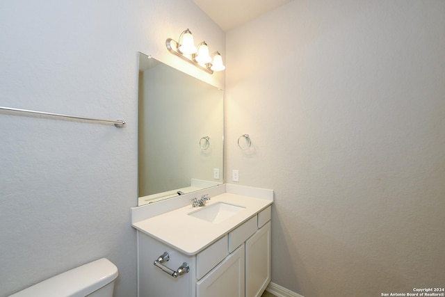 bathroom featuring toilet and vanity