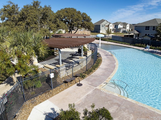 community pool with fence and a residential view