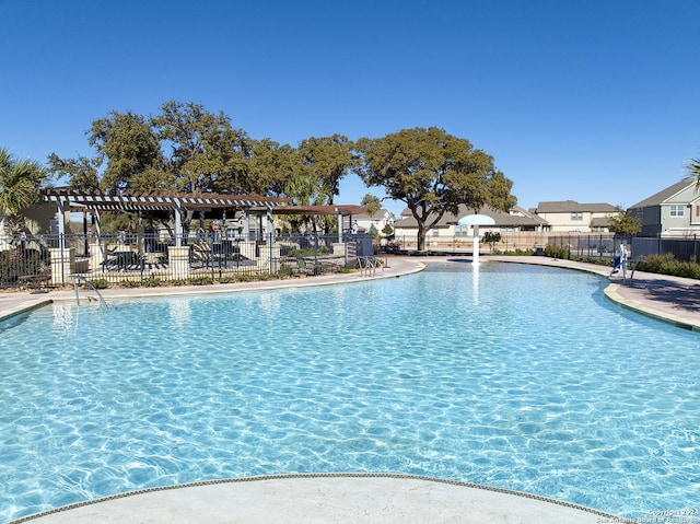 pool featuring a patio, fence, and a pergola