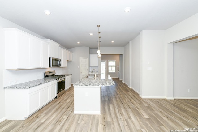 kitchen featuring white cabinetry, light wood-style flooring, appliances with stainless steel finishes, and a sink