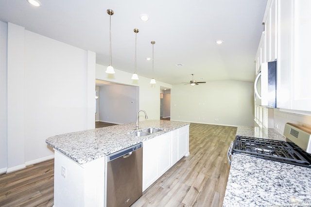 kitchen with ceiling fan, white cabinetry, appliances with stainless steel finishes, and a sink