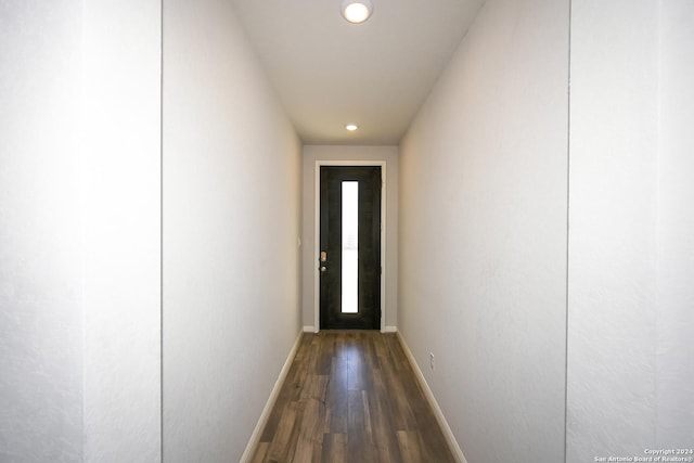 doorway to outside featuring dark wood finished floors, recessed lighting, and baseboards