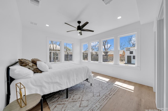 bedroom with visible vents, recessed lighting, and wood finished floors