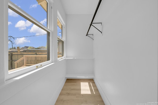 walk in closet featuring wood finished floors