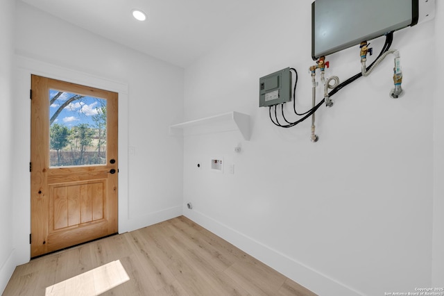 laundry room featuring baseboards, light wood-type flooring, laundry area, hookup for a washing machine, and electric dryer hookup