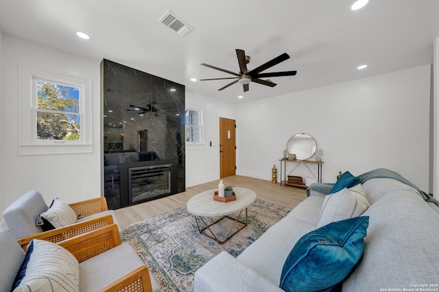 living room featuring recessed lighting, visible vents, wood finished floors, and ceiling fan