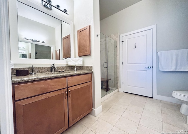 full bathroom with vanity, toilet, baseboards, and a stall shower