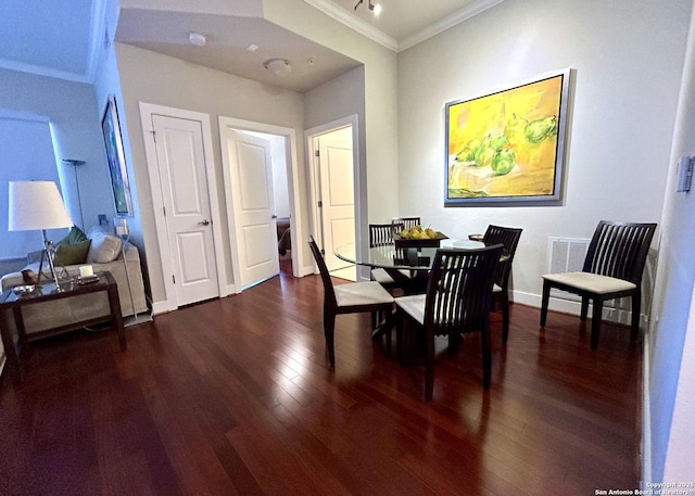 dining space featuring visible vents, crown molding, baseboards, and dark wood-style flooring