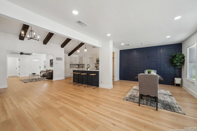 dining space featuring light wood finished floors, visible vents, beamed ceiling, and recessed lighting