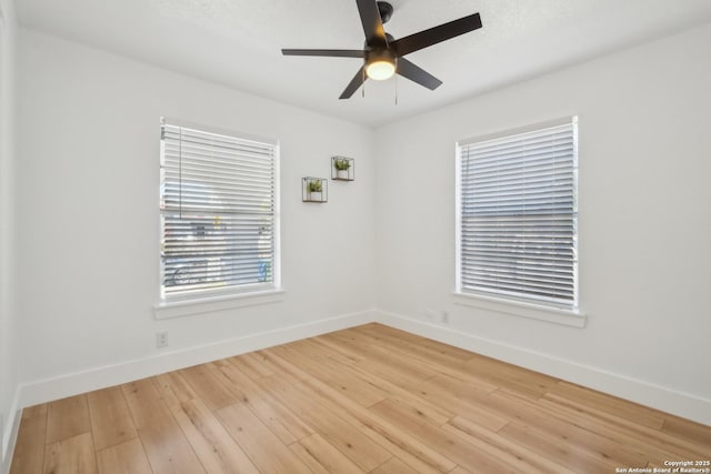 unfurnished room featuring baseboards, ceiling fan, and light wood finished floors