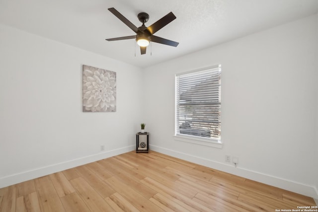 empty room featuring a ceiling fan, wood finished floors, and baseboards