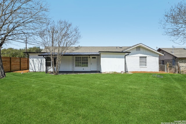 back of property featuring a lawn and a fenced backyard