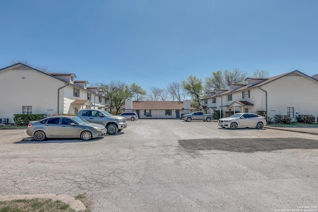 uncovered parking lot with a residential view