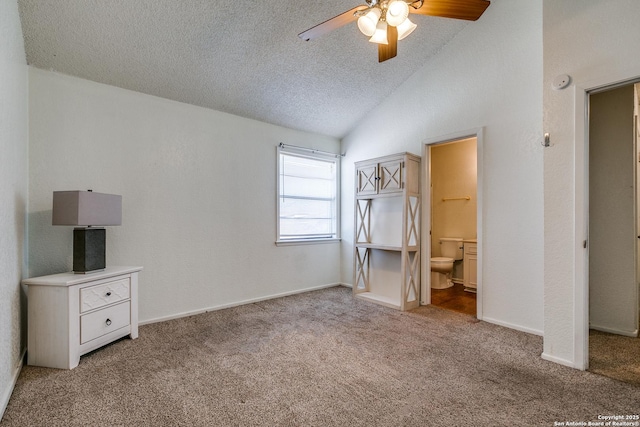 unfurnished bedroom with baseboards, carpet floors, ensuite bath, lofted ceiling, and a textured ceiling