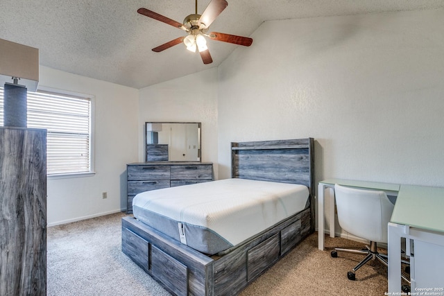 bedroom with a ceiling fan, carpet, baseboards, vaulted ceiling, and a textured ceiling