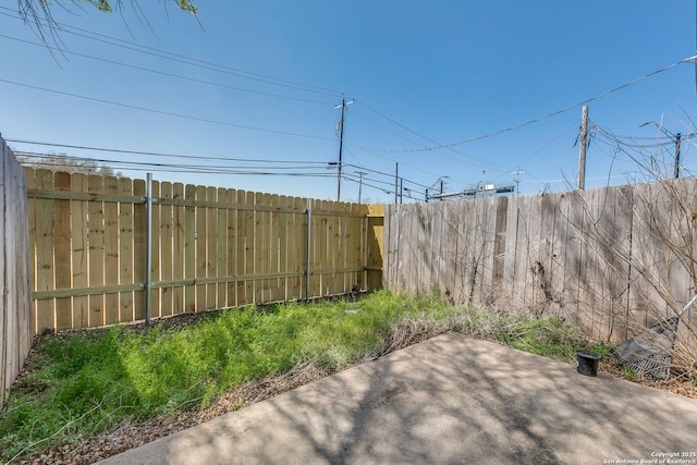 view of yard with a patio and a fenced backyard