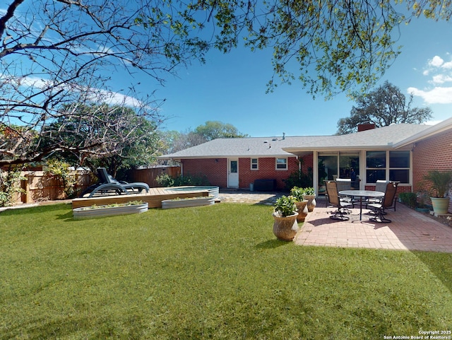 view of yard featuring a patio area, a fenced backyard, and a hot tub