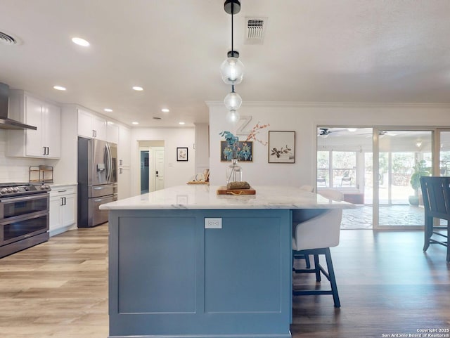 kitchen featuring visible vents, light stone countertops, light wood-type flooring, white cabinets, and stainless steel appliances