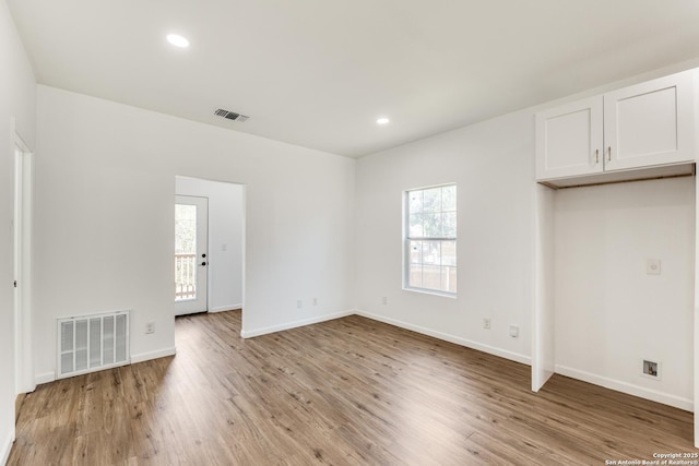 interior space with light wood-style flooring, recessed lighting, baseboards, and visible vents