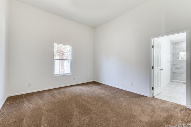 carpeted spare room with baseboards