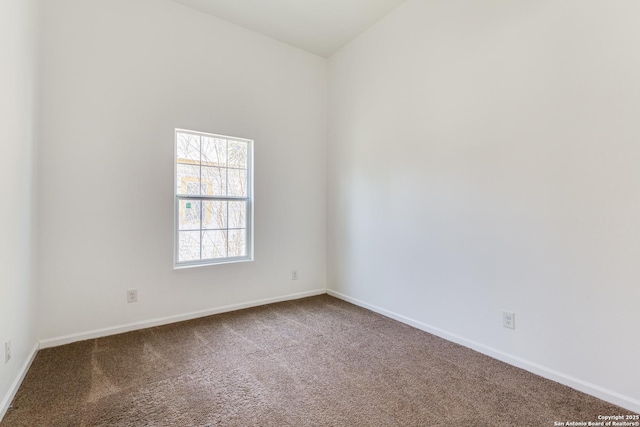 spare room with baseboards and carpet