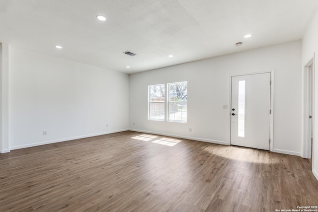 foyer entrance featuring visible vents, recessed lighting, baseboards, and wood finished floors