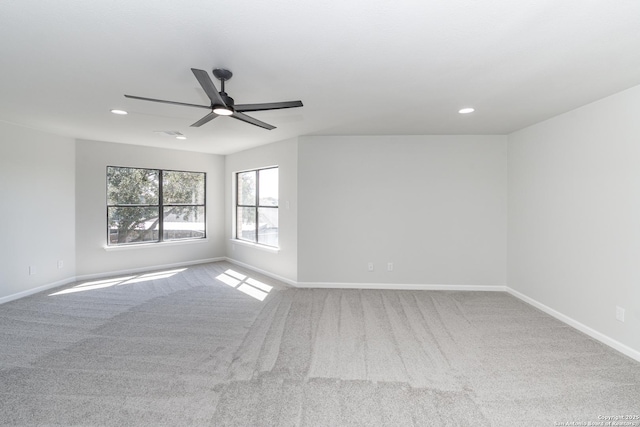 empty room with baseboards, carpet floors, and a ceiling fan