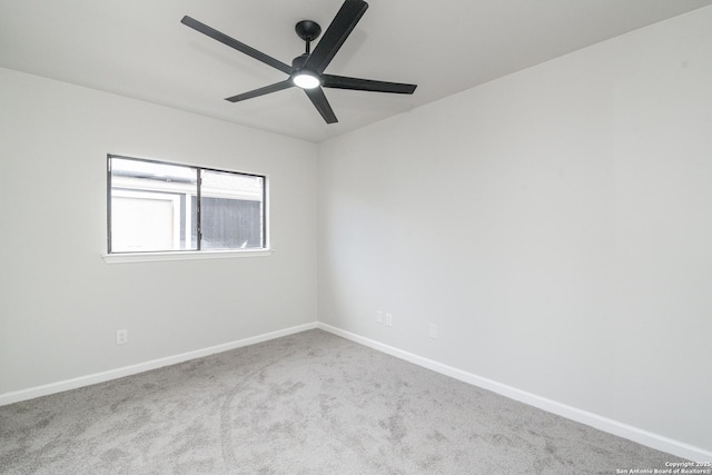 carpeted empty room with baseboards and ceiling fan