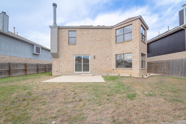 back of house featuring a patio, brick siding, a fenced backyard, and a lawn