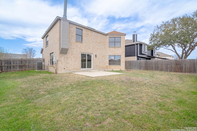 back of property featuring a patio, a yard, a fenced backyard, and brick siding