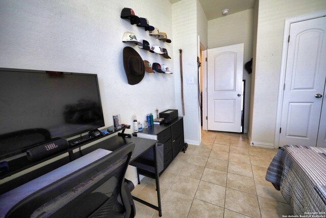 home office with light tile patterned floors and baseboards