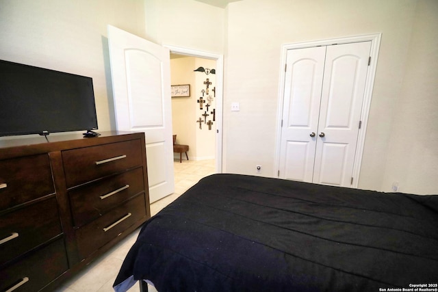 bedroom featuring light tile patterned floors and a closet