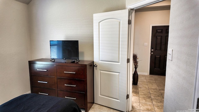 bedroom featuring light tile patterned floors