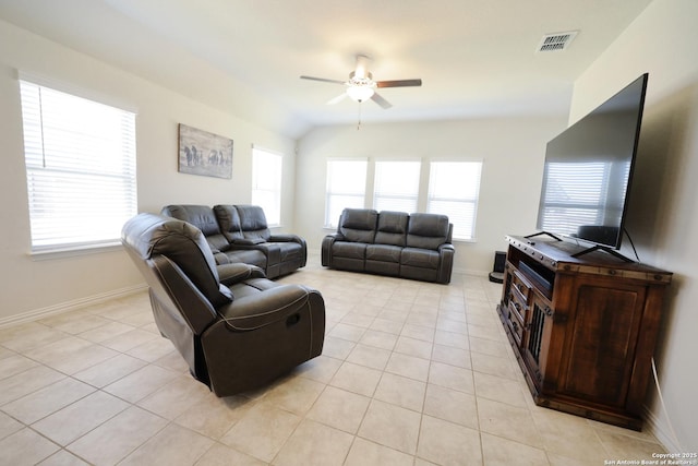 living area with vaulted ceiling, light tile patterned floors, visible vents, and ceiling fan