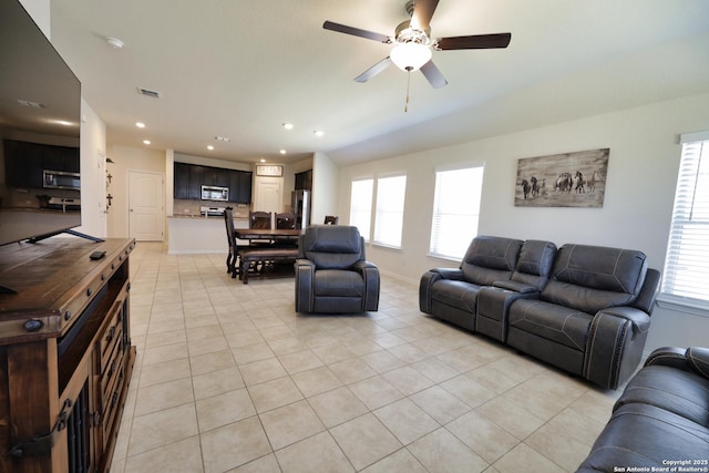 living area with visible vents, recessed lighting, light tile patterned flooring, baseboards, and ceiling fan