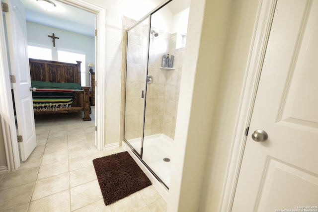 ensuite bathroom featuring tile patterned flooring, a shower stall, and ensuite bath