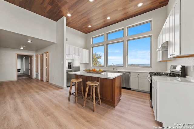 301 Vip Dr, Canyon Lake, TX 78133 - kitchen featuring a kitchen island, stainless steel appliances, extractor fan, light countertops, and wood ceiling