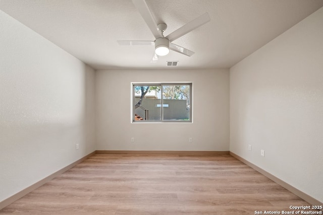 301 Vip Dr, Canyon Lake, TX 78133 - spare room with light wood-style flooring, a ceiling fan, visible vents, and baseboards